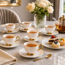 Decorative White Tea Cups and Matching Saucers