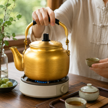 2L Gold-Tone Tea Kettle with Black Grip Handle and Lid